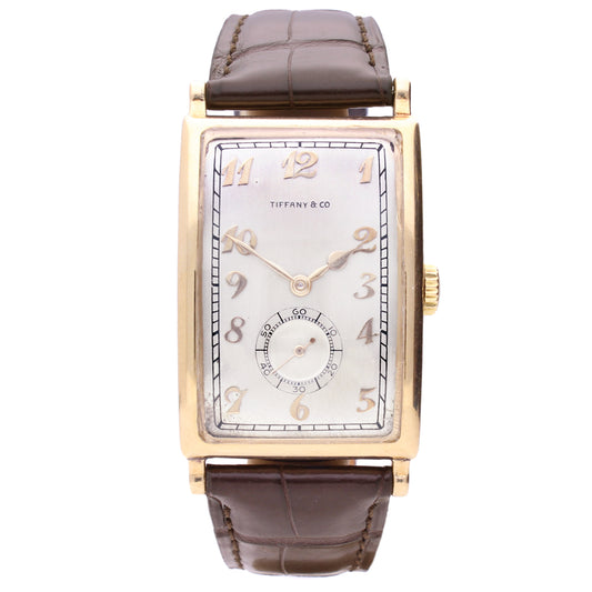 18ct yellow gold Patek Philippe, ref. 431 rectangular curved wristwatch, retailed by TIFFANY. Made 1940