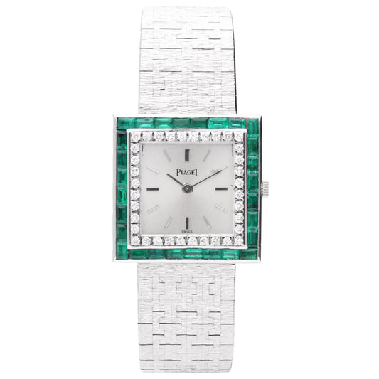 18ct white gold Piaget ref. 9203 square case bracelet watch with diamond and emerald set bezel. Made 1970