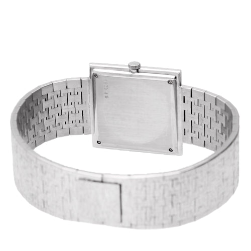 18ct white gold Piaget ref. 9203 square case bracelet watch with diamond and emerald set bezel. Made 1970