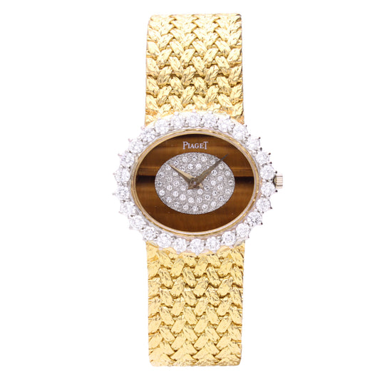 18ct yellow gold Piaget Oval case bracelet watch with tigers eye dial and diamond set bezel. Made 1970