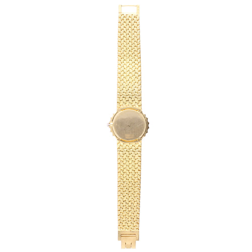 18ct yellow gold Piaget Oval case bracelet watch with tigers eye dial and diamond set bezel. Made 1970